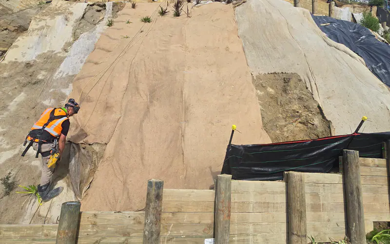 Crew rebuilding a failed slope face after a slip