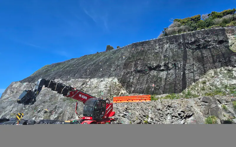 Technician suspended on a steep volcanic slope