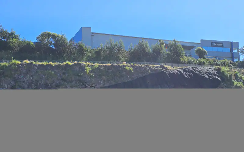 Completed rockfall mesh fixed across a rock face